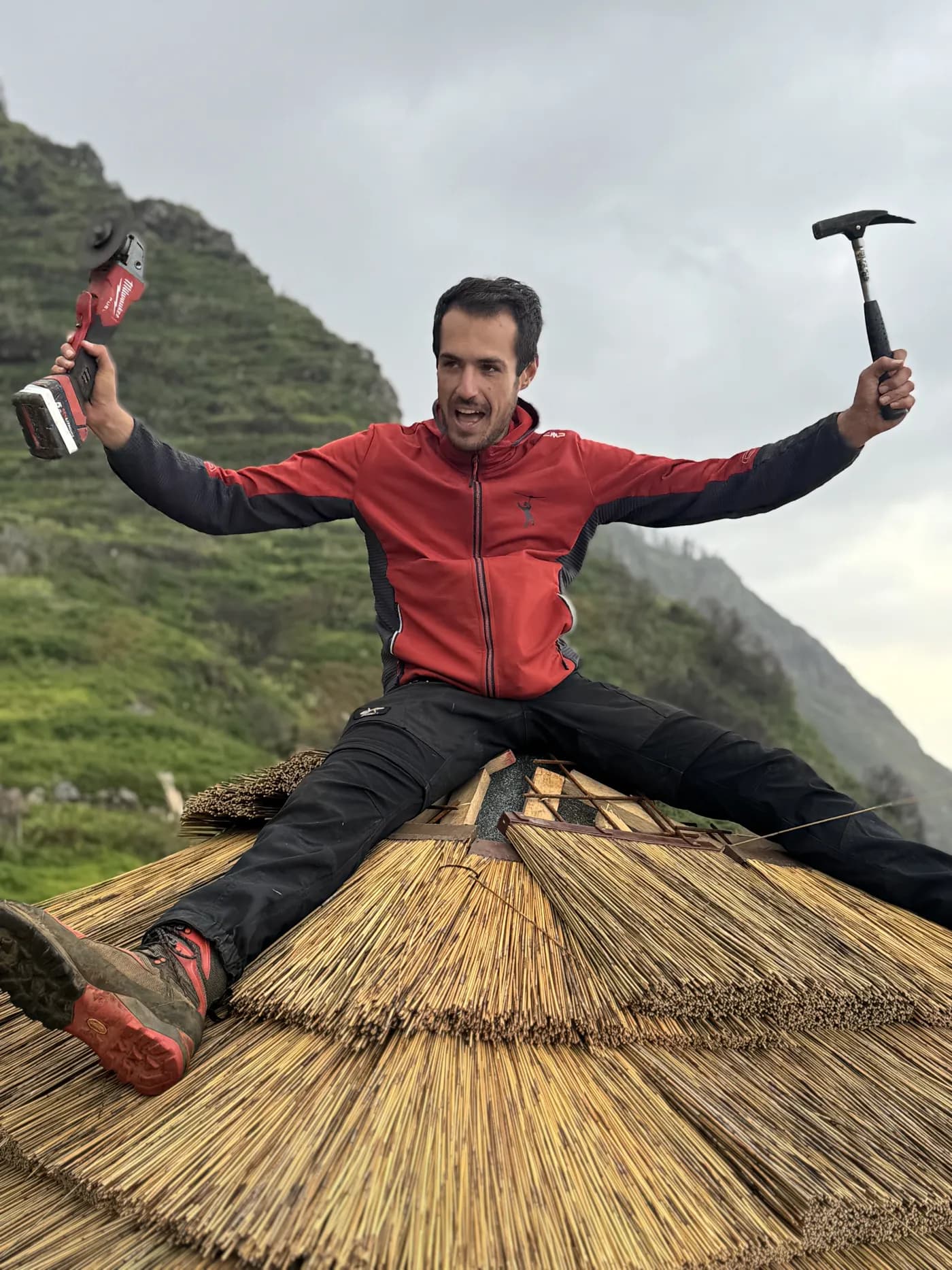 Founder of Adrenaline Adventures on the thatched roof of the park hut