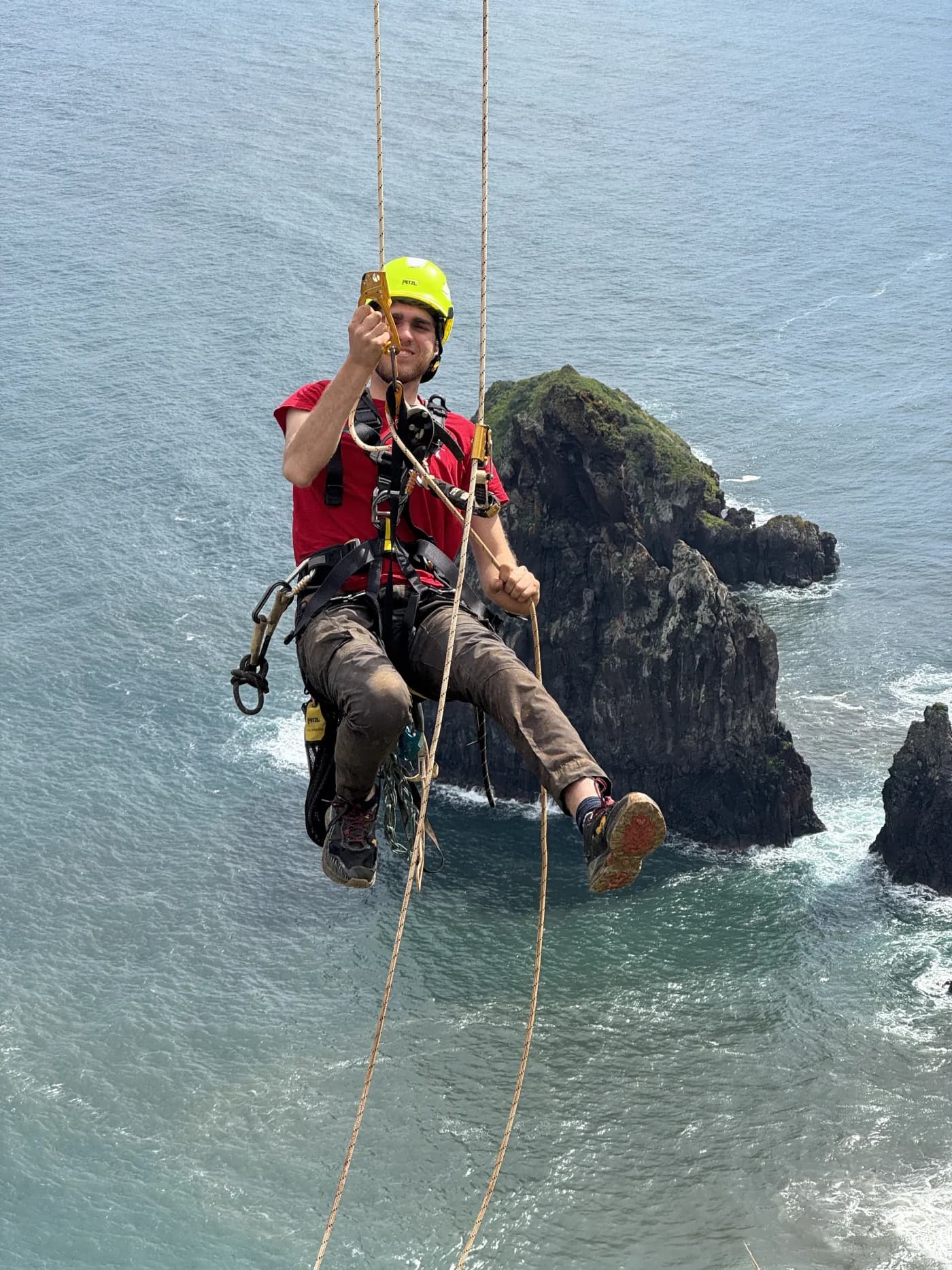 Team member working on the zipline cables above the Atlantic ocean