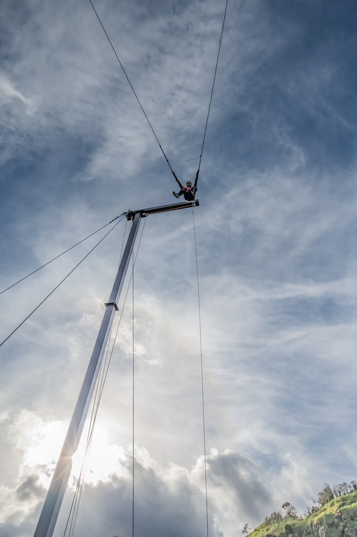 Giant swing drop seen from below against the sky